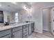 The primary bathroom features double vanity with granite countertop and modern lighting at 9973 Worchester St, Commerce City, CO 80022
