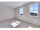 Bright bedroom features carpet flooring, neutral walls and two windows offering natural light at 9973 Worchester St, Commerce City, CO 80022