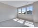 Bright bedroom features carpet flooring, neutral walls and three windows offering views of the neighborhood at 9973 Worchester St, Commerce City, CO 80022