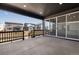 Covered patio with concrete flooring and black railing, offering a great space for relaxation and entertaining at 9973 Worchester St, Commerce City, CO 80022