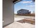 View from the doorway of a gray home showing the street and nearby residences in a new community at 9973 Worchester St, Commerce City, CO 80022