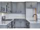 Charming kitchen featuring gray cabinets, stainless steel appliances, and granite countertops at 9973 Worchester St, Commerce City, CO 80022