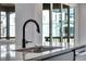 Modern kitchen with gray cabinetry, granite countertops, and stainless steel sink at 9973 Worchester St, Commerce City, CO 80022