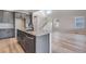 Stylish kitchen boasts gray cabinets, granite countertops and stainless steel dishwasher at 9973 Worchester St, Commerce City, CO 80022