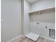 Bright laundry room features wood-look flooring and ample space for appliances and storage at 9973 Worchester St, Commerce City, CO 80022