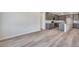 Spacious open-plan living room and kitchen with vinyl plank flooring at 9973 Worchester St, Commerce City, CO 80022