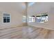 Bright living room offers soaring ceilings, large windows and attractive light wood floors at 9973 Worchester St, Commerce City, CO 80022