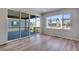 Bright living room featuring vinyl floors and large windows offering neighborhood views at 9973 Worchester St, Commerce City, CO 80022