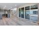 Open living room with stairs, sliding glass doors to patio, and views of kitchen at 9973 Worchester St, Commerce City, CO 80022