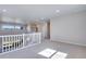 Spacious loft area features carpet flooring, recessed lighting, neutral walls, and white staircase railing at 9973 Worchester St, Commerce City, CO 80022
