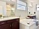 Bathroom with soaking tub, double vanity, tiled shower, and ample counter space at 17630 W 94Th Dr, Arvada, CO 80007