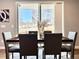 Dining room with hardwood floors, a modern table, and view of the neighborhood at 17630 W 94Th Dr, Arvada, CO 80007