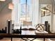 Close up of a home office desk with stylish decor and natural light from a window at 17630 W 94Th Dr, Arvada, CO 80007