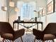 Home office featuring a modern desk, stylish decor, and comfortable seating at 17630 W 94Th Dr, Arvada, CO 80007