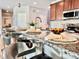 Close-up of a kitchen island with seating, a granite countertop, and modern fixtures at 17630 W 94Th Dr, Arvada, CO 80007