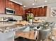 Gourmet kitchen featuring stainless steel appliances and granite countertops with bar stool seating at 17630 W 94Th Dr, Arvada, CO 80007
