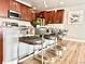Stylish kitchen island with seating, stainless steel appliances, and modern lighting at 17630 W 94Th Dr, Arvada, CO 80007