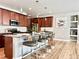 Modern kitchen featuring a spacious island, stainless steel appliances, and wooden cabinetry at 17630 W 94Th Dr, Arvada, CO 80007