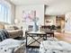 Stylish living room with modern furniture, a decorative rug, and an open layout at 17630 W 94Th Dr, Arvada, CO 80007