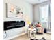 Cozy living room with electric fireplace, stylish decor, and comfortable seating at 17630 W 94Th Dr, Arvada, CO 80007