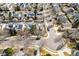 An aerial view of a neighborhood with well-maintained homes, mature trees, and quiet streets at 6324 Winona St, Arvada, CO 80003