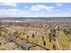 Overhead view of the community showcasing the park, tennis court and Denver skyline in the distance at 6324 Winona St, Arvada, CO 80003