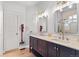 Contemporary bathroom featuring double sinks and a walk-in shower at 6324 Winona St, Arvada, CO 80003