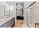 Stylish bathroom boasting double sink vanity and walk-in shower at 6324 Winona St, Arvada, CO 80003
