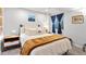 Comfortable bedroom with a bed with a throw blanket and a 