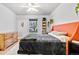 Bright bedroom featuring a orange upholstered headboard, plush carpet, and natural light at 6324 Winona St, Arvada, CO 80003