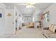 Bright bedroom featuring neutral walls, natural light, with a crib, and gray couch at 6324 Winona St, Arvada, CO 80003