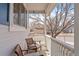 Relaxing front porch view, showcasing seating and a glimpse of the neighborhood at 6324 Winona St, Arvada, CO 80003