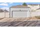 Two-car garage with white panel door, offering convenient and secure parking at 6324 Winona St, Arvada, CO 80003