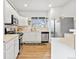 Well-organized kitchen featuring stainless steel appliances, white cabinetry and ample counter space at 6324 Winona St, Arvada, CO 80003