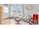 Cozy living space showcases a comfortable sofa, hardwood floors, and bright natural light at 6324 Winona St, Arvada, CO 80003