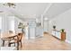 Bright, open-concept living space featuring hardwood floors and a kitchen with modern white cabinetry at 6324 Winona St, Arvada, CO 80003