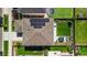 Aerial view of a home with solar panels and a well-maintained backyard with outdoor seating at 6099 N Netherland Ct, Aurora, CO 80019