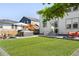 Well-manicured backyard with a hot tub, patio furniture, and lush artificial turf at 6099 N Netherland Ct, Aurora, CO 80019