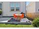 Patio and backyard featuring a table, chairs, grill, and lush landscaping at 6099 N Netherland Ct, Aurora, CO 80019