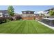 Lush backyard featuring pristine artificial grass and a sleek hot tub for relaxation at 6099 N Netherland Ct, Aurora, CO 80019