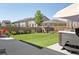 Green backyard with a hot tub and lounge seating at 6099 N Netherland Ct, Aurora, CO 80019