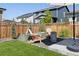 Backyard with seating, privacy fence, and garden beds at 6099 N Netherland Ct, Aurora, CO 80019