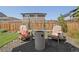 Cozy backyard with seating and outdoor fire pit at 6099 N Netherland Ct, Aurora, CO 80019