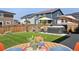 Backyard with green grass, hot tub, patio, and wood fence at 6099 N Netherland Ct, Aurora, CO 80019
