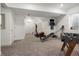 Spacious basement with carpeting, exercise equipment, and a staircase at 6099 N Netherland Ct, Aurora, CO 80019