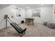 Finished basement space with Total Gym, foosball table and plenty of natural light at 6099 N Netherland Ct, Aurora, CO 80019