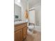 Clean bathroom with wood floors and plenty of storage at 6099 N Netherland Ct, Aurora, CO 80019