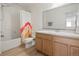 Cozy bathroom featuring tile floors and wood vanity at 6099 N Netherland Ct, Aurora, CO 80019