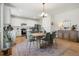 A kitchen with an island flows into a spacious dining area featuring stylish decor and bright natural light at 6099 N Netherland Ct, Aurora, CO 80019