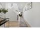 Bright foyer showcases light wood floors, white walls, and a modern staircase at 6099 N Netherland Ct, Aurora, CO 80019
